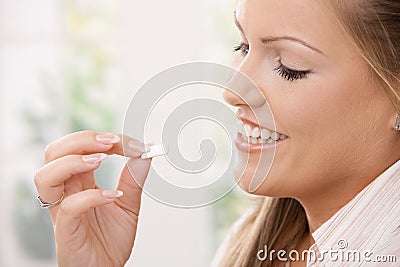 Girl taking chewing gum Stock Photo