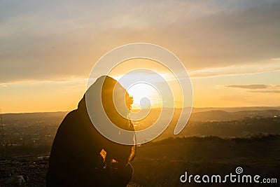 Girl taking photos during colored sunset in quarry Hady Brno with view inside city Stock Photo