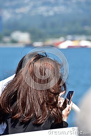 Girl taking a picture with a smart phone. Stock Photo