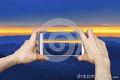 Girl taking pictures on mobile smart phone in phu kradung,Thailand Stock Photo