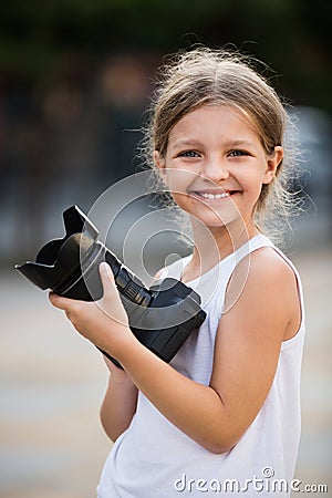 Girl taking pictures with professional camera outdoors Stock Photo