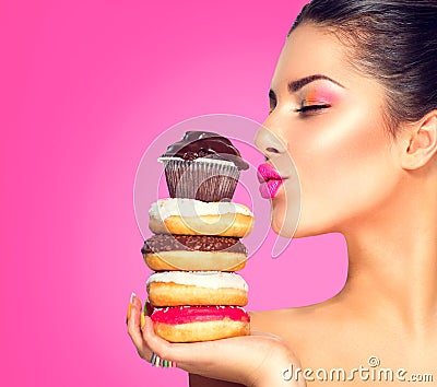 Girl taking sweets and colorful donuts Stock Photo