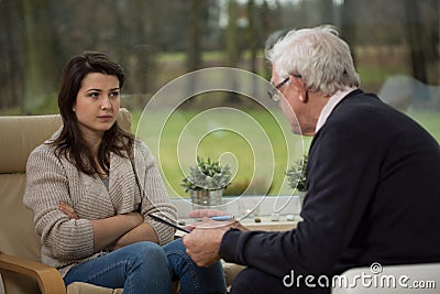 Girl talking with elder psychiatrist Stock Photo