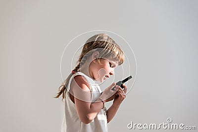 Girl talking over walkie-talkie Stock Photo