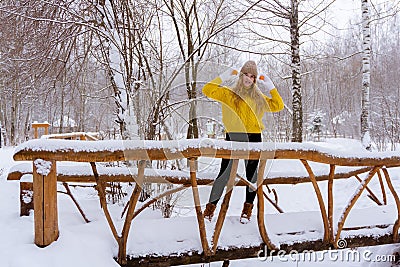 Girl with tangerines in winter park Stock Photo