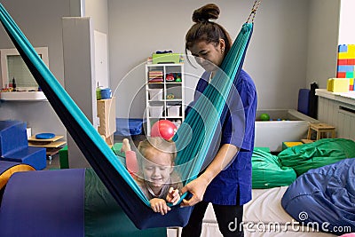 Girl in tape made of elastic material. sensory experience, enhance tactile and sensitivity Stock Photo