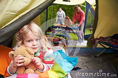 Girl With Teddy Bear Enjoying Camping Holiday On Campsite Stock Photo