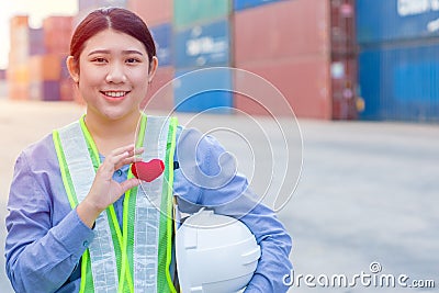 Girl teen worker in cargo container shipping port working with heart and good service mind concept Stock Photo