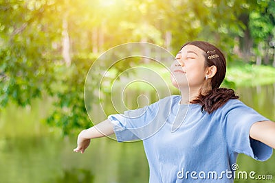 Girl teen young open arms fully breathe fresh clean ozone air in green outdoor park Stock Photo