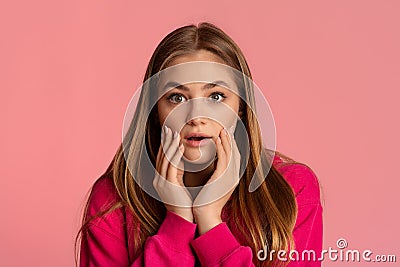 Girl teenager is surprises and touches face with hands Stock Photo