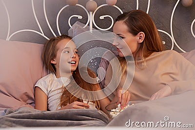 Girl telling secrets to mother Stock Photo