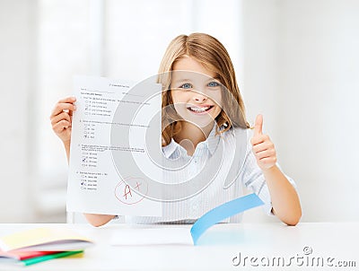 Girl with test and grade at school Stock Photo