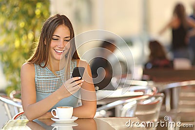 Girl texting on the phone in a restaurant Stock Photo