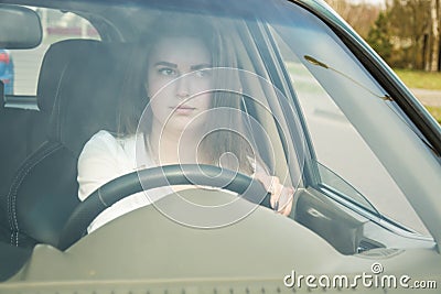 The girl thoughtfully drives the car, drives the car. Woman driving Stock Photo