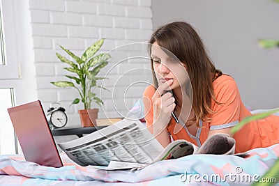 Girl thoughtfully reads with job offers announcements Stock Photo