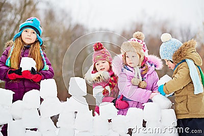 Girl with three little children build wall Stock Photo