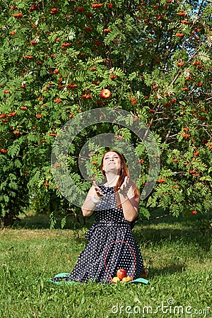 Girl throws up apple Stock Photo