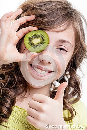 Girl thumb up for kiwi green vitamins Stock Photo