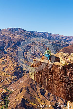 Girl tourist on an extreme ledge in the rock Troll tongue Stock Photo