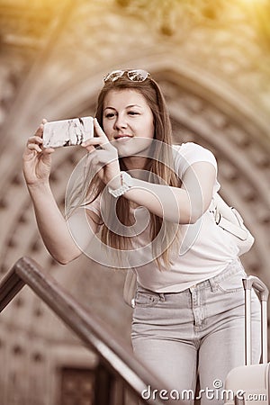 Girl tourist is taking photo on her phone Stock Photo