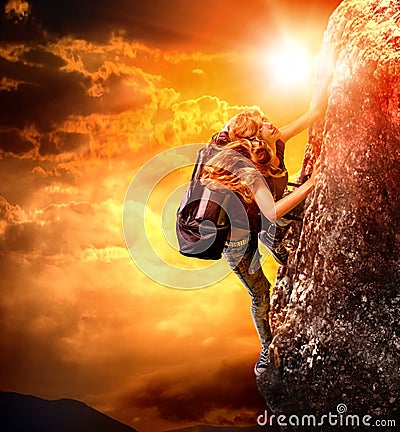 Girl tourists climbing on rock with backpack Stock Photo