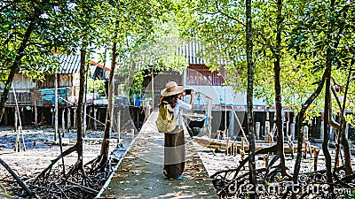 The Girl tourists walking taking pictures The way of life of the villagers in rural villages Ban Bang Phat - Phangnga. summer, Stock Photo