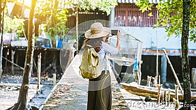 The Girl tourists walking taking pictures The way of life of the villagers in rural villages Ban Bang Phat - Phangnga. summer, Stock Photo