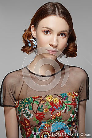 Girl in transparent blouse and colorful corset with natural make up and hairdo Stock Photo