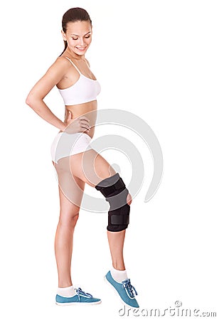 Girl with trauma of knee in brace. Stock Photo