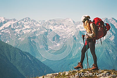 Girl Traveler hiking with backpack at rocky mountains Stock Photo