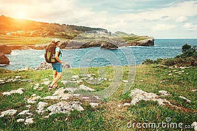 Girl traveler looks on beautiful sea landscape Stock Photo