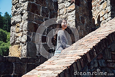 Girl traveler visiting old medieval castle walk Stock Photo