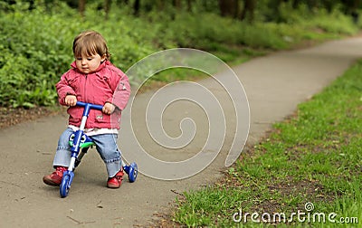 Girl on a tricycle Stock Photo