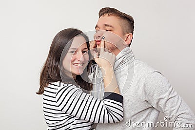 The girl tries to cheer up her boyfriend Stock Photo