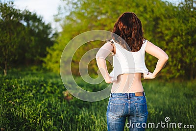 Girl tries on a white tank top Stock Photo
