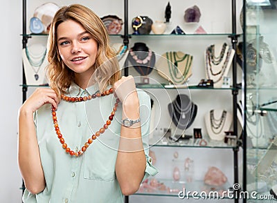 Girl trying on cornelian stone necklace Stock Photo