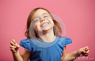 Girl trying to frighten someone with stretched hands Stock Photo