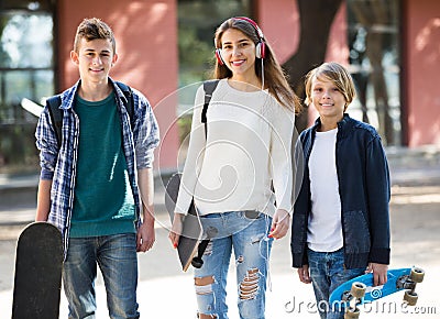Girl and two boys with skateboards Stock Photo