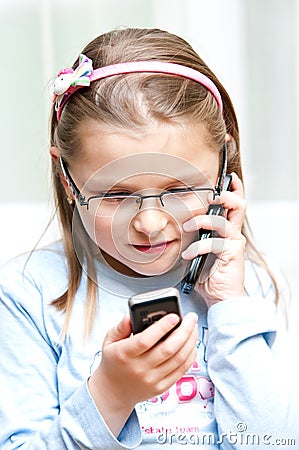 Girl with two mobile phones Stock Photo