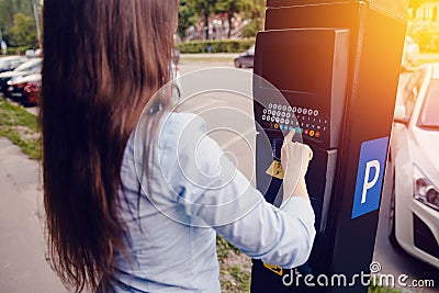 Girl types the text with her hands for making out the ticket for parking machine parking and payment for travel Stock Photo