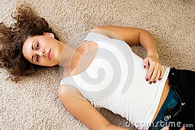 Girl unbuttoned jeans - Lying on the floor Stock Photo