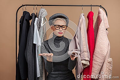 Girl is unhappy as she cannot put on her old clothes as she has gained weight Stock Photo