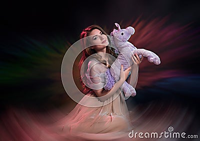 Young woman holding a unicorn toy Stock Photo