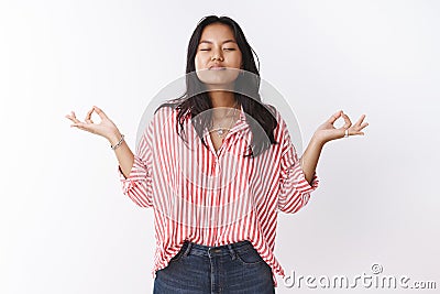 Girl uniting with nature meditation showing mudra sign sideways close eyes and inhaling air, practicing yoga in lotus Stock Photo