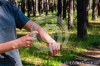 Girl uses the spray against mosquitoes Stock Photo