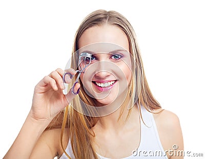 Girl using an eyelash curler Stock Photo