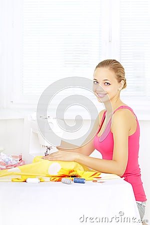 Girl using sewing machine to sew clothing Stock Photo