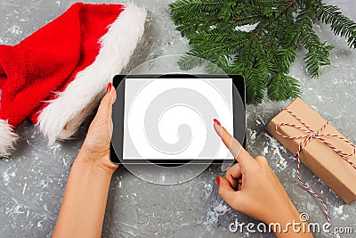 Girl using tablet technology in home, person holding computer on background Christmas decoration, female hands texting, mockup tem Stock Photo