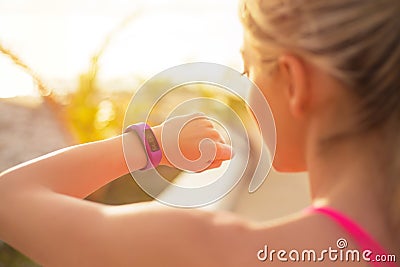 Girl using wearable tech during morning workout Stock Photo