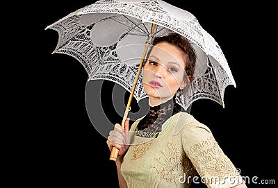 Girl in Victorian dress holding a white umbrella Stock Photo